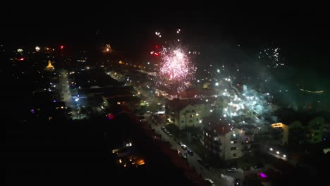 The-drone-captures-a-dazzling-display-of-fireworks-illuminating-the-night-sky-as-the-year-comes-to-an-end,-creating-a-spectacular-and-celebratory-visual-feast