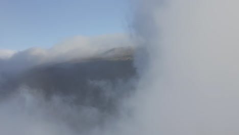 Fly-through-white-clouds-moving-over-the-slopes-of-Haleakala-volcano-on-Maui-at-daylight