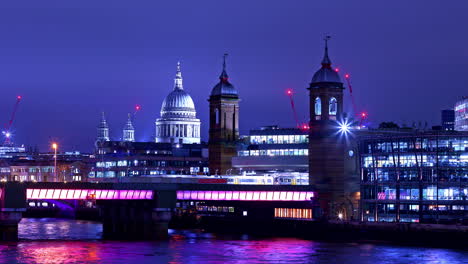 Time-lapse-of-train-traffic-on-Cannon-Street-Railway-Bridge-over-river-Thames-at-night-time-with-St