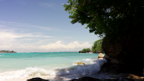 Bali,-Indonesia---Waves-Crashing-Against-the-Rocky-Shore-of-a-Tropical-Beach-in-Nusa-Lembongan---Medium-Shot