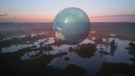 A-Globe-Representing-Planet-Earth-Hovering-Above-a-Marshy-Landscape---Forward-Shot