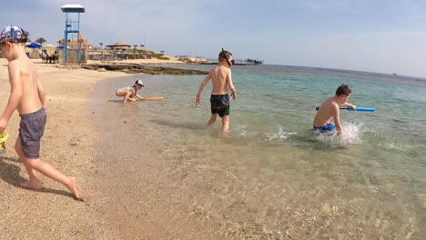 Kids-Playing-With-Spray-Water-Pump-Toys-At-The-Beach-In-Summer-In-Egypt