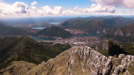 Stunning-aerial-drone-panoramic-view-of-Resegone-mountain-range-and-lakes-of-Italian-Alps-in-northern-Italy