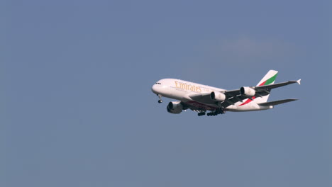 Descending-and-deploying-its-landing-gears-as-it-prepares-to-land-at-the-tarmac-of-Suvharmabhumi-airport-in-Bangkok,-Thailand