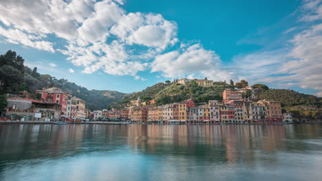 Timelapse-view-over-harbor-of-clouds-in-blue-sky-flying-over-scenic-Portofino