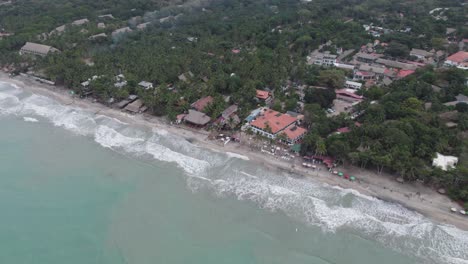 Panning-drone-shot-of-Palomino-Beach,-La-Guajira-in-Colombia