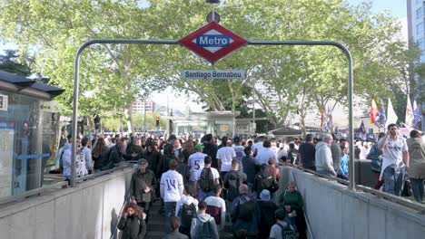 Real-Madrid-fans-exit-the-Santiago-Bernabeu-metro-station-as-they-arrive-at-the-Real-Madrid-stadium-to-attend-the-Champions-League-football-between-Real-Madrid-and-Manchester-City-teams