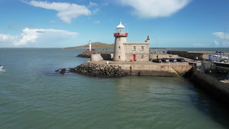 Howth-Ireland-low-drone-lighthouse-flyover-afternoon-bright-sun-crystal-blue-water