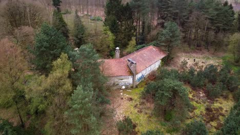 Aerial-above-abandoned-house-in-the-belgian-forest-countryside