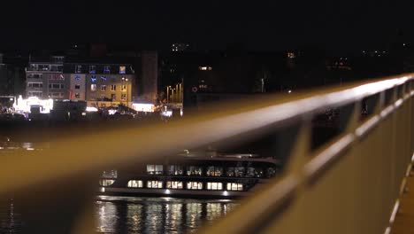 Indulge-in-the-romance-of-a-nighttime-river-cruise-on-the-Rhine,-with-Cologne's-breathtaking-bridges-and-skyline-providing-a-stunning-backdrop-for-an-unforgettable-voyage