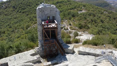 Tourist-In-The-Tower-In-The-Ancient-Thracian-City-Of-Perperikon,-Bulgaria---Drone-Pullback