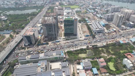 Aerial-footage-shot-of-shell-building-with-traffic-in-highway