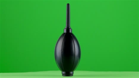 photography-videography-blower-rocket-soft-air-enema-on-green-background-chroma-key-background-replacement-backdrop-objet-in-a-turntable-3d-spinning-loop