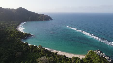 Aerial-view,-above-costal-island,-intensely-blue-sea-and-relaxing-panorama,-Tayrona-National-Park