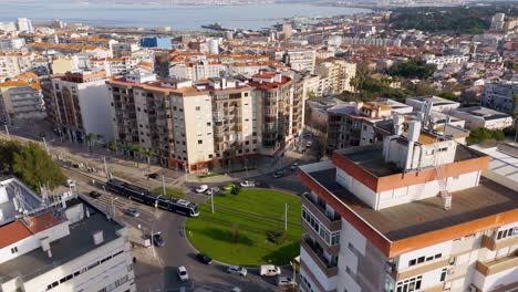 City-view-with-tram-and-trafic-in-Almada-and-Base-Naval-de-Lisboa,-Portugal