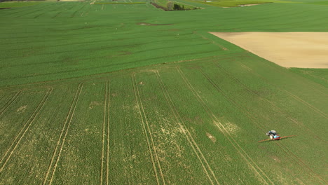 Tractor-Spread-Slurry-On-Pasture-Farm-Field-in-Spring-season-during-sunny-day