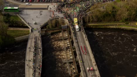 Drone-top-down-rotate-and-descend-around-parade-floats-and-people-gathering-outside-of-Galway-Cathedral