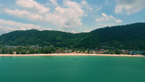 4K-Cinematic-nature-drone-footage-of-a-panoramic-aerial-view-of-the-beautiful-beaches-and-mountains-on-the-island-of-Koh-Lanta-in-Krabi,-South-Thailand,on-a-sunny-day