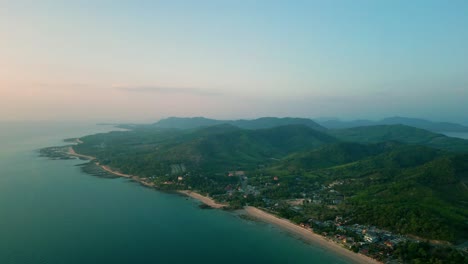 4K-Cinematic-nature-drone-footage-of-a-panoramic-aerial-view-of-the-beautiful-beaches-and-mountains-on-the-island-of-Koh-Lanta-in-Krabi,-South-Thailand,-during-sunset