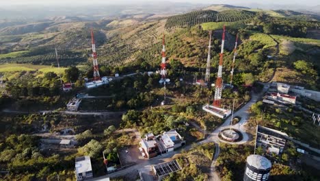Radio-and-telecommunication-antennas-on-hill-surrounded-by-crop-fields