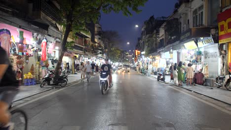 Bustling-city-streets-illuminated-by-lights-of-traffic-and-open-shops