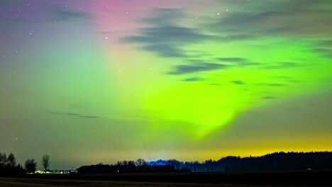 Northern-lights-show-in-multiple-colors-across-Latvia-countryside,-aurora-shimmer-throughout-the-sky