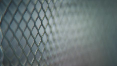 A-hyper-macro-shot-of-a-metal-grid,-steel-pattern,-iron-industrial-texture,-aluminum-material,-super-slow-motion,-Full-HD-120-fps,-tilt-up-movement