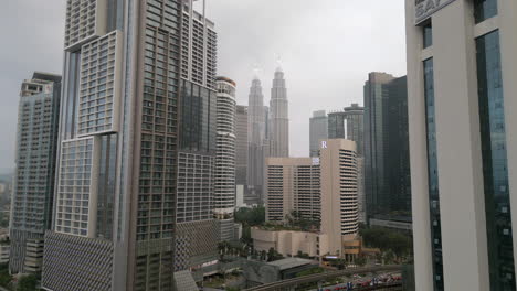 Drone-Rise-Track-In-Between-Kuala-Lumpur-Skyscrapers