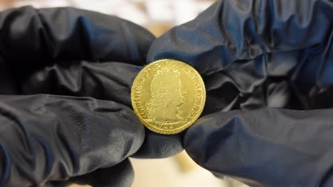 Collector-examining-Portuguese-ancient-golden-coin