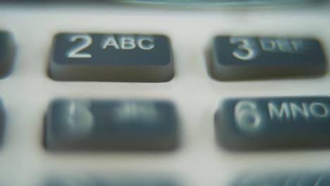 A-macro-close-up-shot-of-a-pin-pad-numbers-and-letters-on-colorful-buttons,-zooming-in-movement,-Full-HD-video,-super-slow-motion,-blurry-depth-of-field