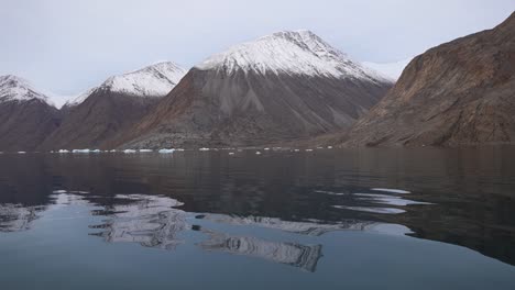 Snow-Capped-Hills-and-Cold-Fjord-Water,-Svalbard,-Norway