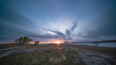 A-sun-ascends-in-the-morning-sky-above-the-calm-fjord-and-the-autumn-tundra