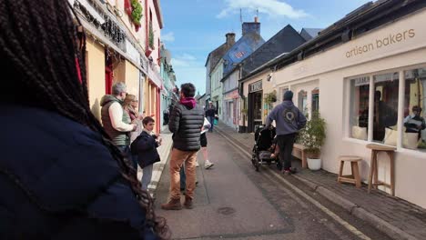 Street-food-festival-and-group-of-young-women-eating-ice-cream,-family,-boys,-walking-and-talking,-Kinsale,-Ireland