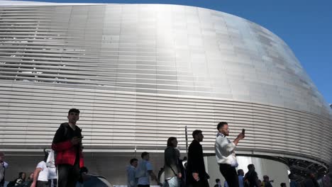 Wide-angle-shot-of-football-fans-arriving-at-Real-Madrid´s-Santiago-Bernabeu-stadium-as-they-attend-the-Champions-League-football-match-against-British-football-team-Manchester-City-club