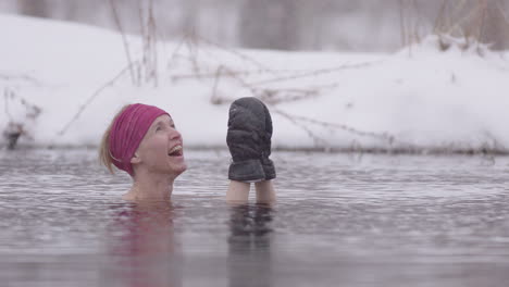 Close-up-of-a-female-ice-bather-looking-up-with-joy-at-the-falling-snow