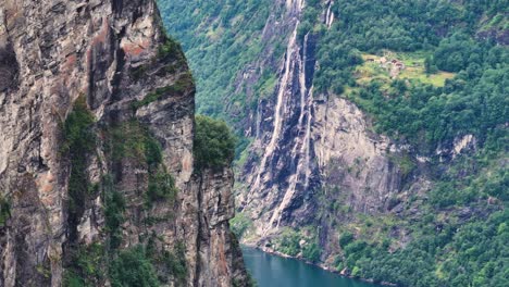 Aerial-View-of-Scenic-Waterfall-and-Steep-Hills-Above-Geiranger-Fjord,-Norway