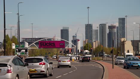 Busy-street-and-skyline-of-Manchester-in-background,-static-view