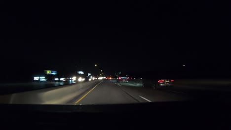 Series-number-one-hyperlapse-showing-car-driving-towards-Dallas-Texas-at-night-passing-cars-in-the-fast-lane,-minimal-overhead-lighting,-and-general-interstate-driving