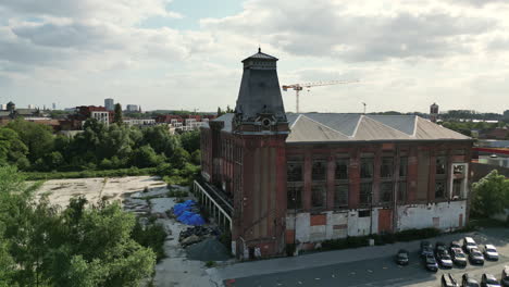 Wide-Circular-Aerial-of-Historic-Abandoned-Building-With-Clock-Tower-in-Ghent,-Belgium