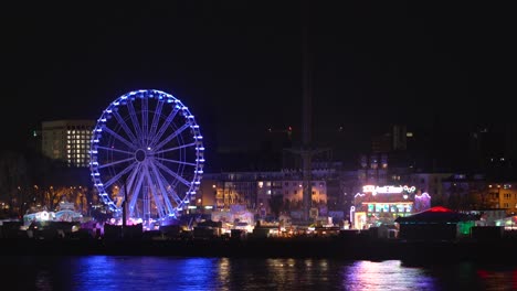 A-vibrant-carnival-comes-to-life-under-the-night-sky,-its-colorful-lights-twinkling-in-the-distance