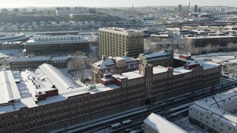 Train-Transportation-Station-Tracks-in-Stockholm,-Sweden-on-Snowy-Winter-Day,-Aerial