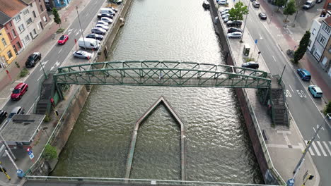 Tilt-Upward-Flying-Off-Above-Wondelgembrug-Canal-Bridge-in-Ghent,-Belgium