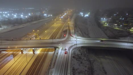 Cars-Driving-Through-Snowy-Highway-At-Night-In-Winter-In-Montreal,-Quebec,-Canada