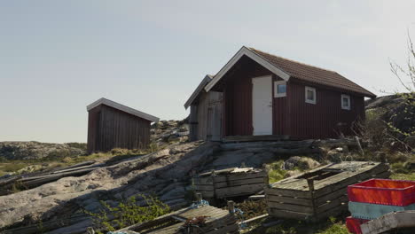 Fisherman's-Hut-Cabins-in-Coastal-Sweden,-Tranquil-Fishing-Village-Scene