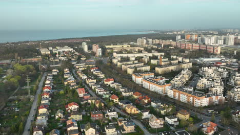 Aerial-flyover-Zabianka-District-of-Gdansk-Town-with-large-low-class-Apartment-buildings-and-Baltic-sea-in-Background