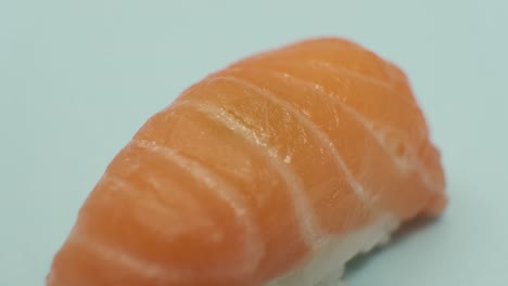 Studio-shot-of-sushi-roll-on-blue-background