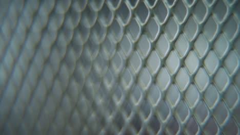 A-hyper-macro-shot-of-a-metal-grid,-steel-pattern,-iron-industrial-texture,-aluminum-material,-super-slow-motion,-Full-HD-120-fps,-pan-right-smooth-movement