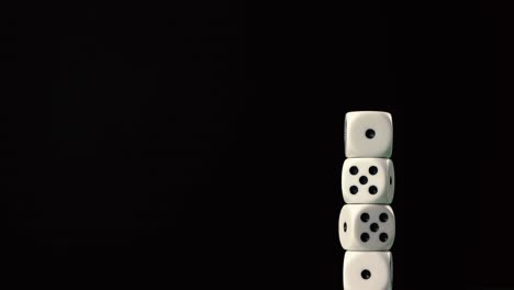 Stacking-dice-on-other-dices-on-black-background,-clean