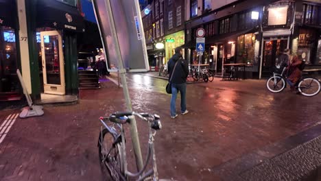 Crossing-street-at-crosswalk,-Amsterdam-night-street-scene-with-Christmas-lights