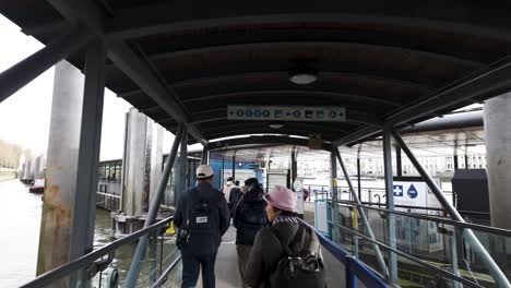 Explorers-stroll-through-the-passage-leading-to-Westminster-Pier-in-London,-embodying-the-spirit-of-travel-and-exploration